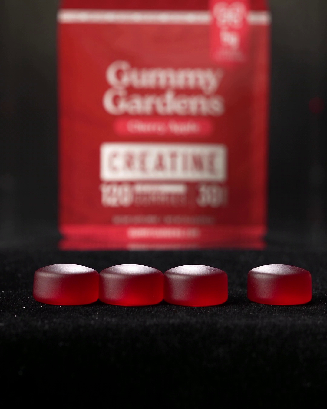 Serving photo: Cherry Apple, one serving is 4 gummies (5g creatine) in front of the pouch