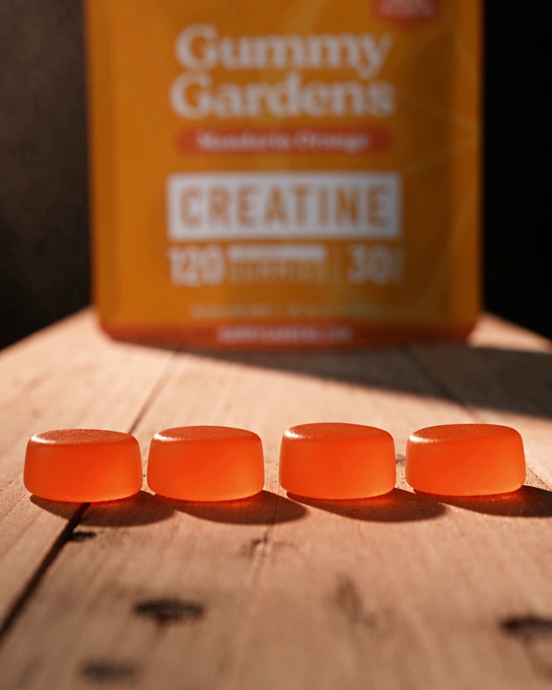 Serving photo: Mandarin Orange, one serving is 4 gummies (5g creatine) in front of the pouch
